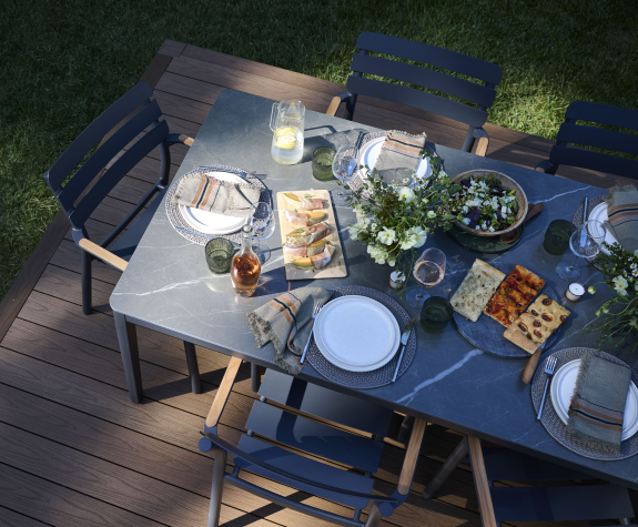 Outdoor dining table sized for family gatherings in a modern patio setup