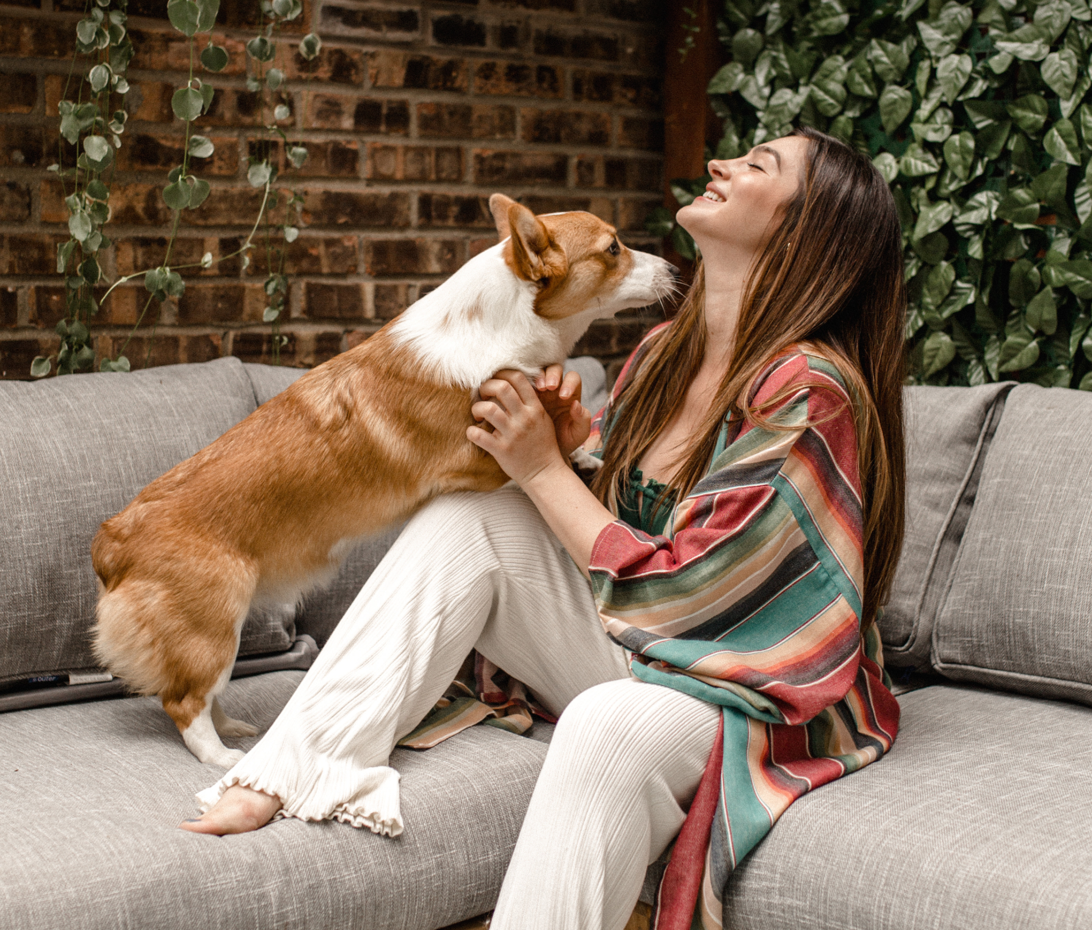women playing with dog in outdoor wicker sofa https://liveouter.com/