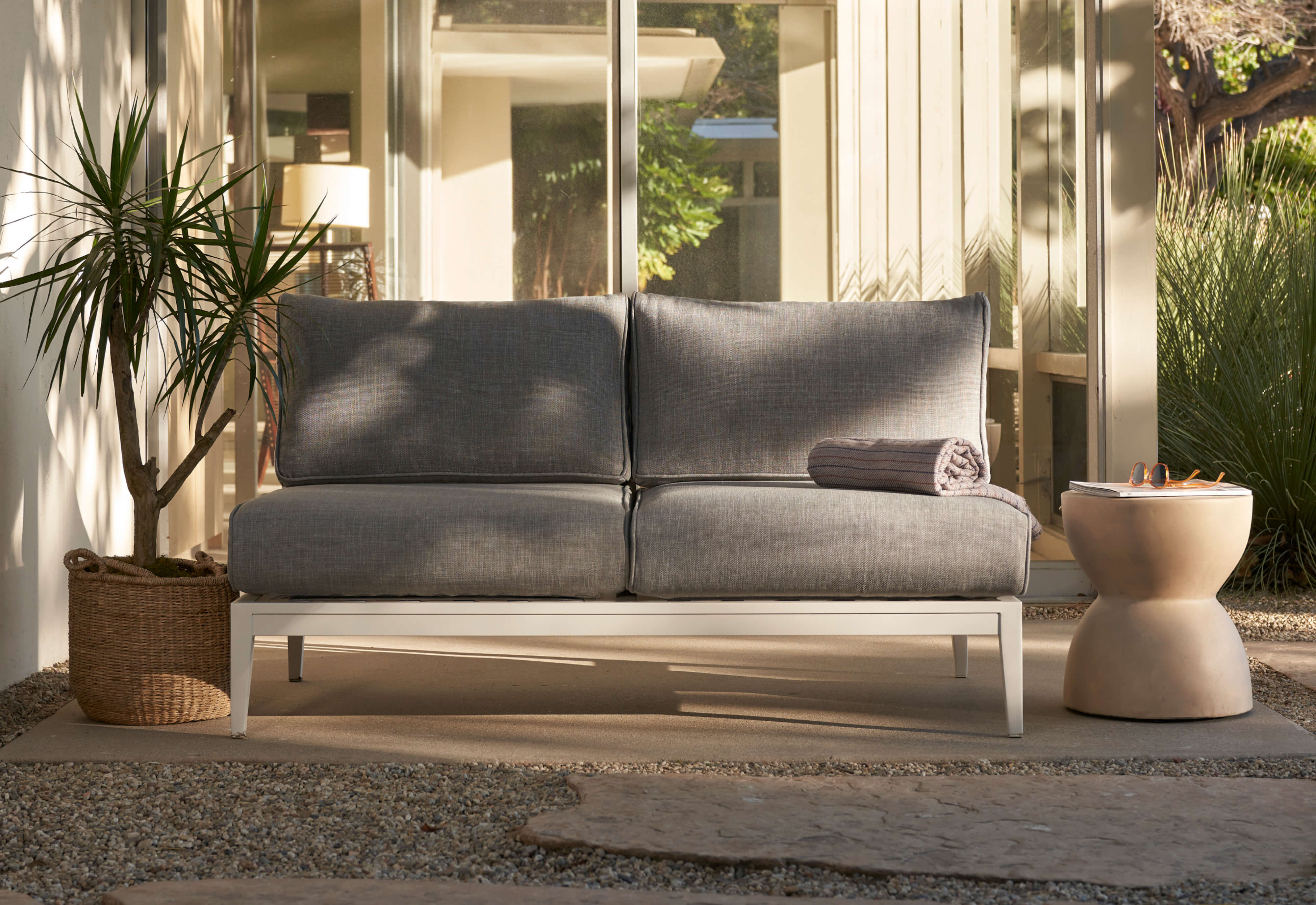 The white aluminum armless loveseat with pacific fog gray fabric. https://liveouter.com/