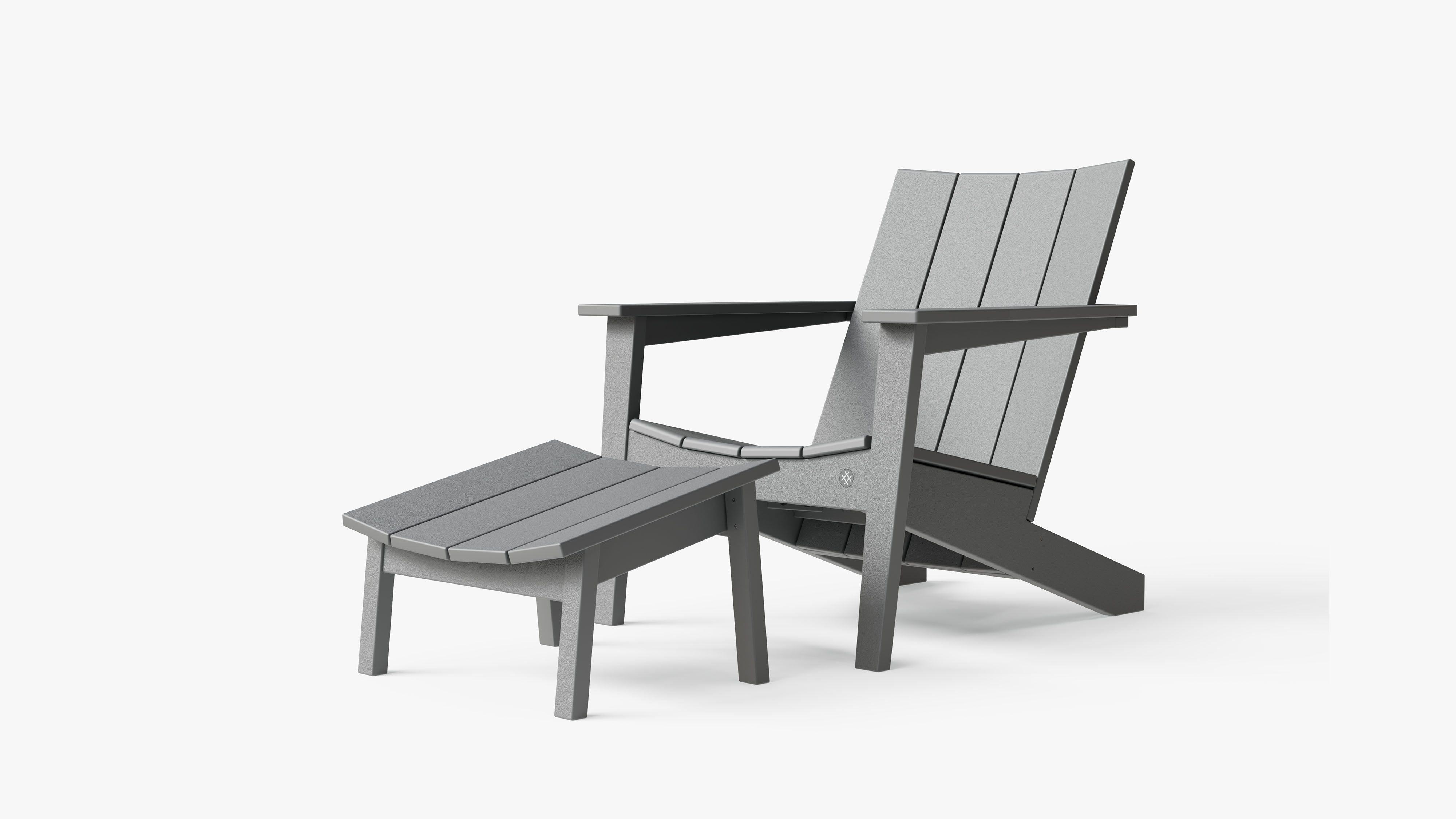 The Ascent Adirondack chair and ottoman, 3/4 view. #color_charcoal