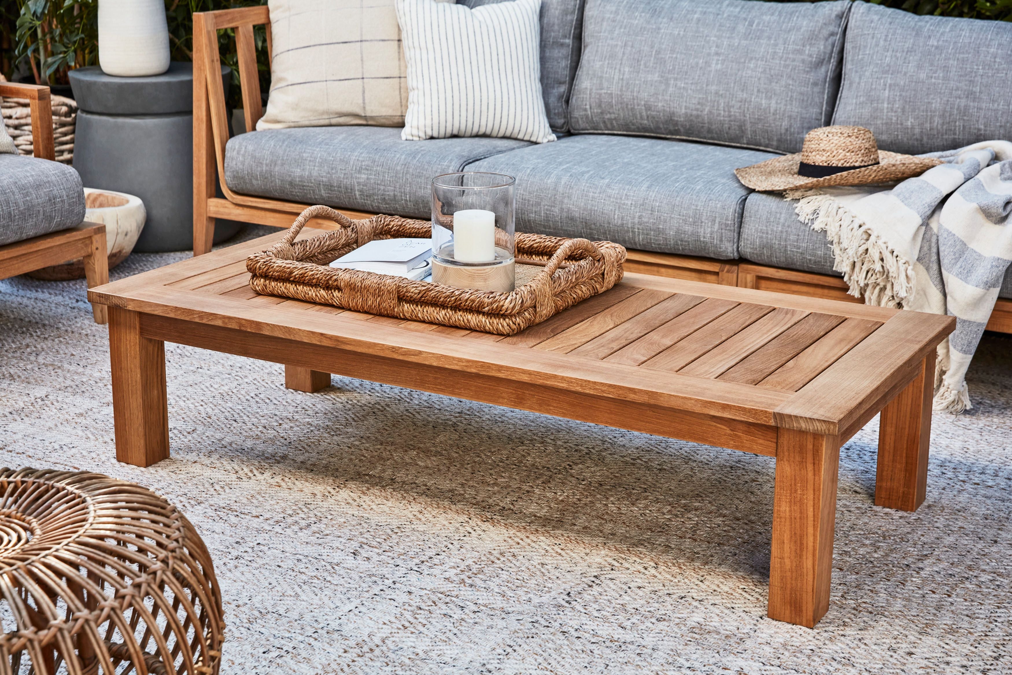 FSC certified teak outdoor coffee table with square legs shown with Outer's durable outdoor rug and sustainable teak sofa. #size_medium