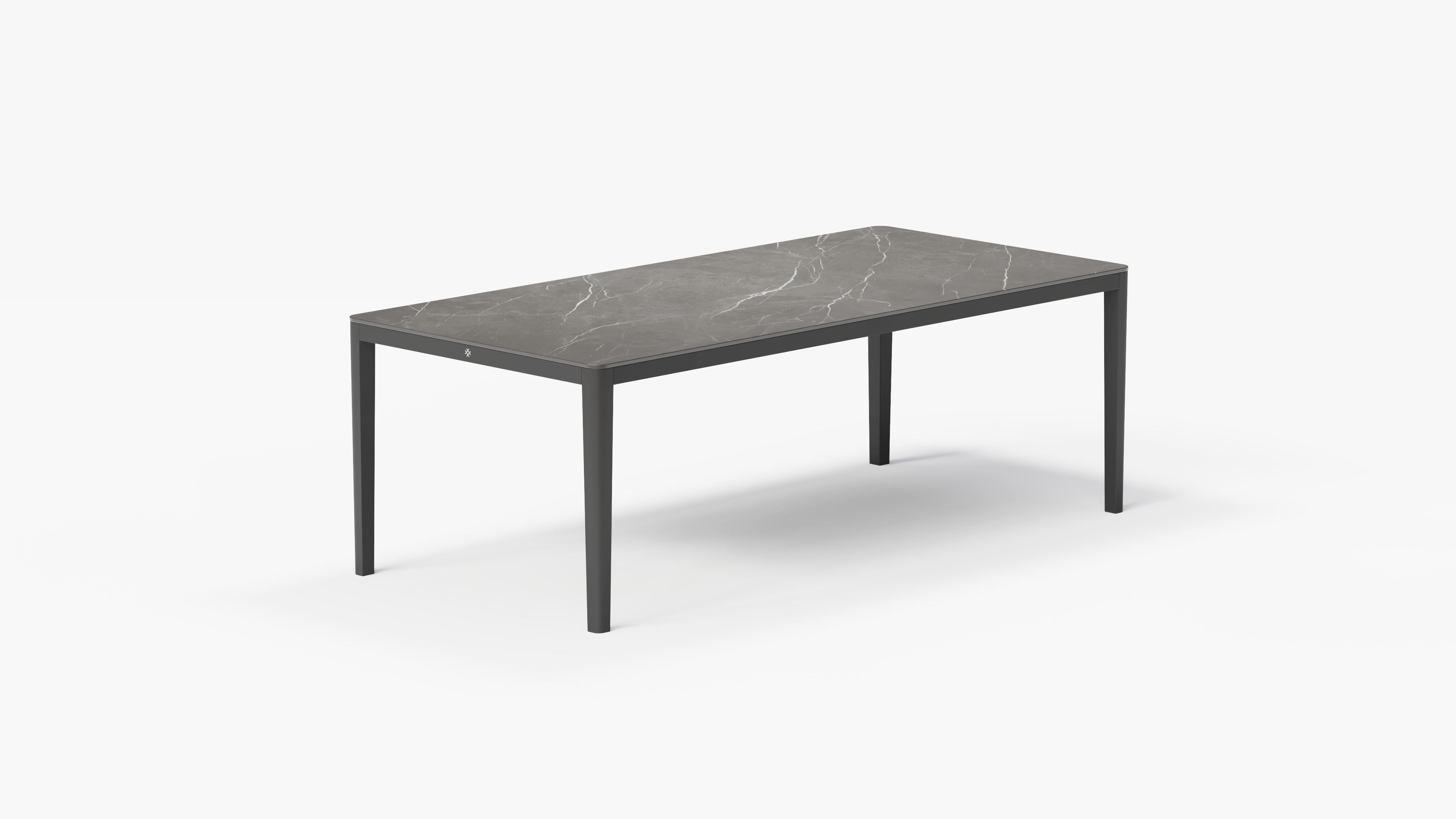 outer-dining table-Charcoal aluminum dining table with gray marble-look sintered stone tabletop shown in a clean studio setting