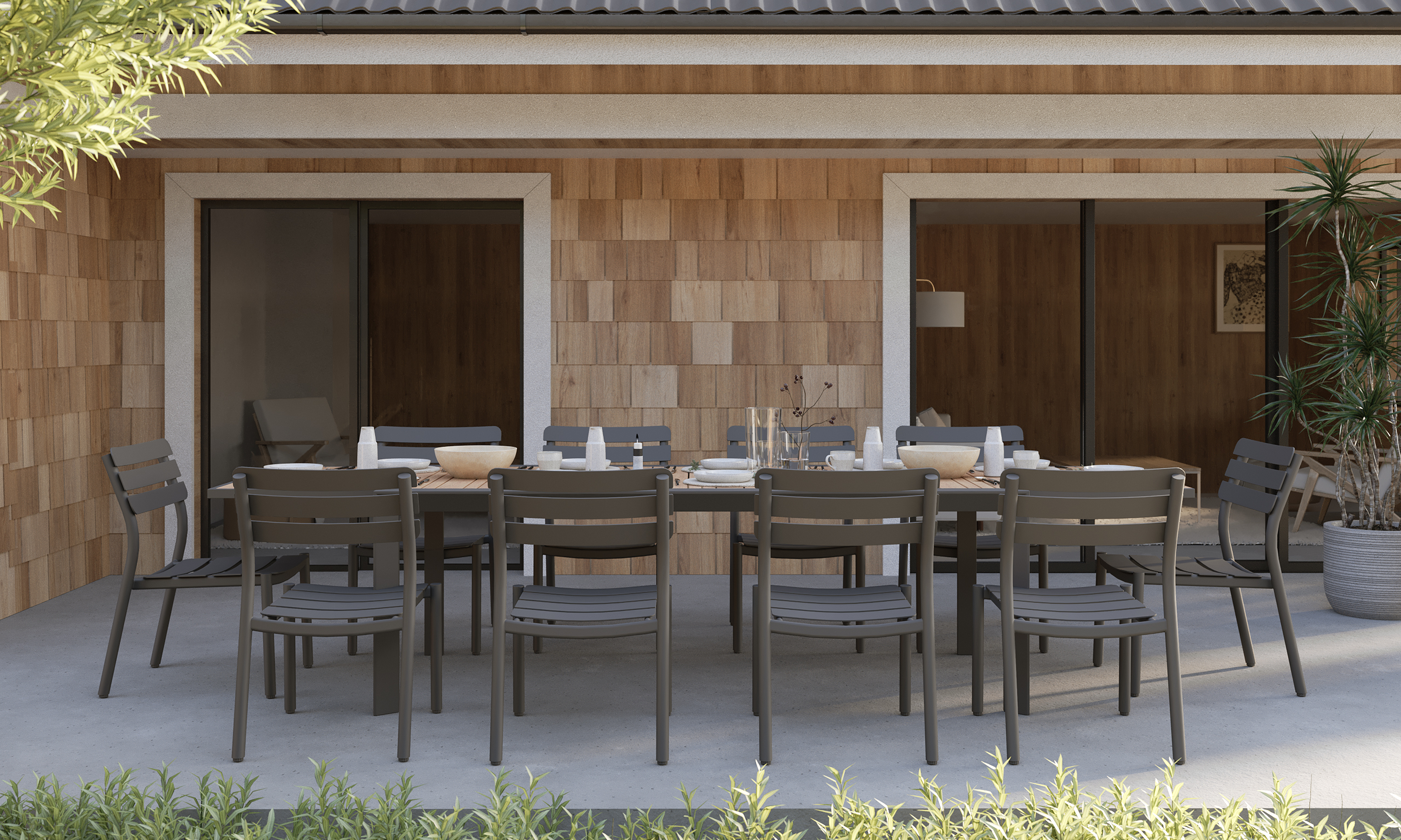 outer-Teak + Aluminum Outdoor Expandable Dining Table + 10 595 Armless Chairs-top down view of long rectangular outdoor expandable dining table set styled for a shared meal with teak tabletop, charcoal aluminum armless chairs, tableware and greenery on modern patio