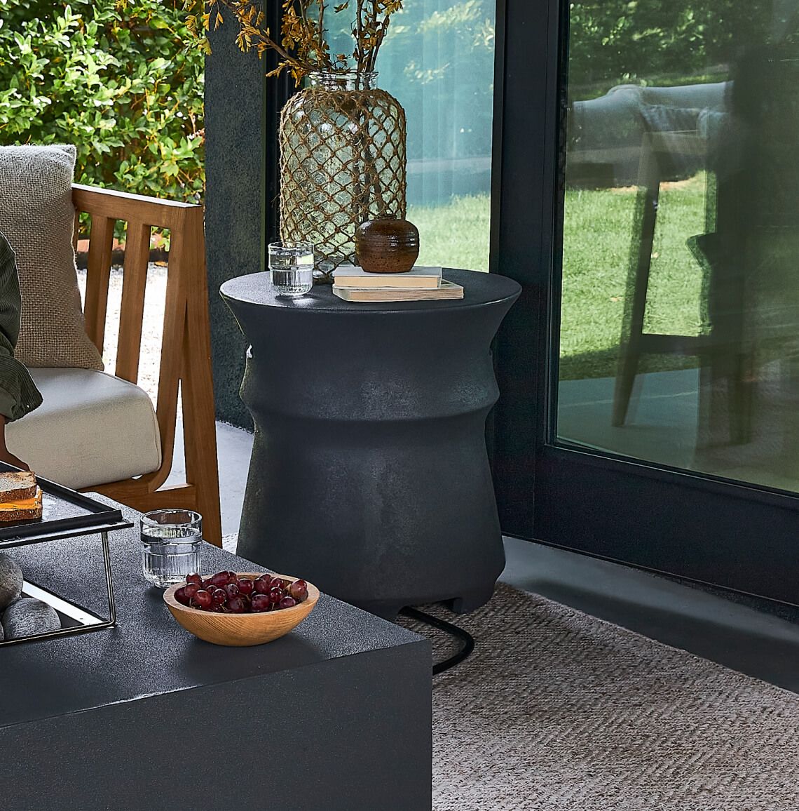 Outer's lightweight concrete outdoor propane tank cover shown in a patio setting. #title_default title