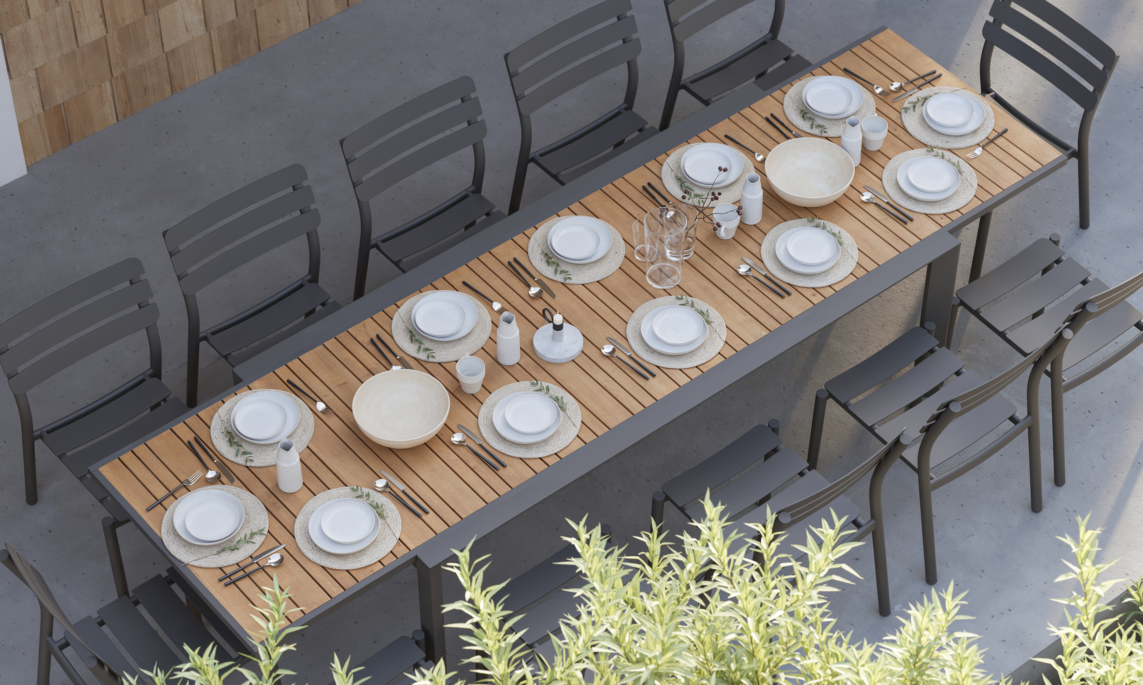 outer-Teak + Aluminum Outdoor Expandable Dining Table + 12 595 Armless Chairs-top down outdoor dining scene with long expandable teak table, charcoal aluminum armless chairs and a fully set table for gathering on a modern patio
