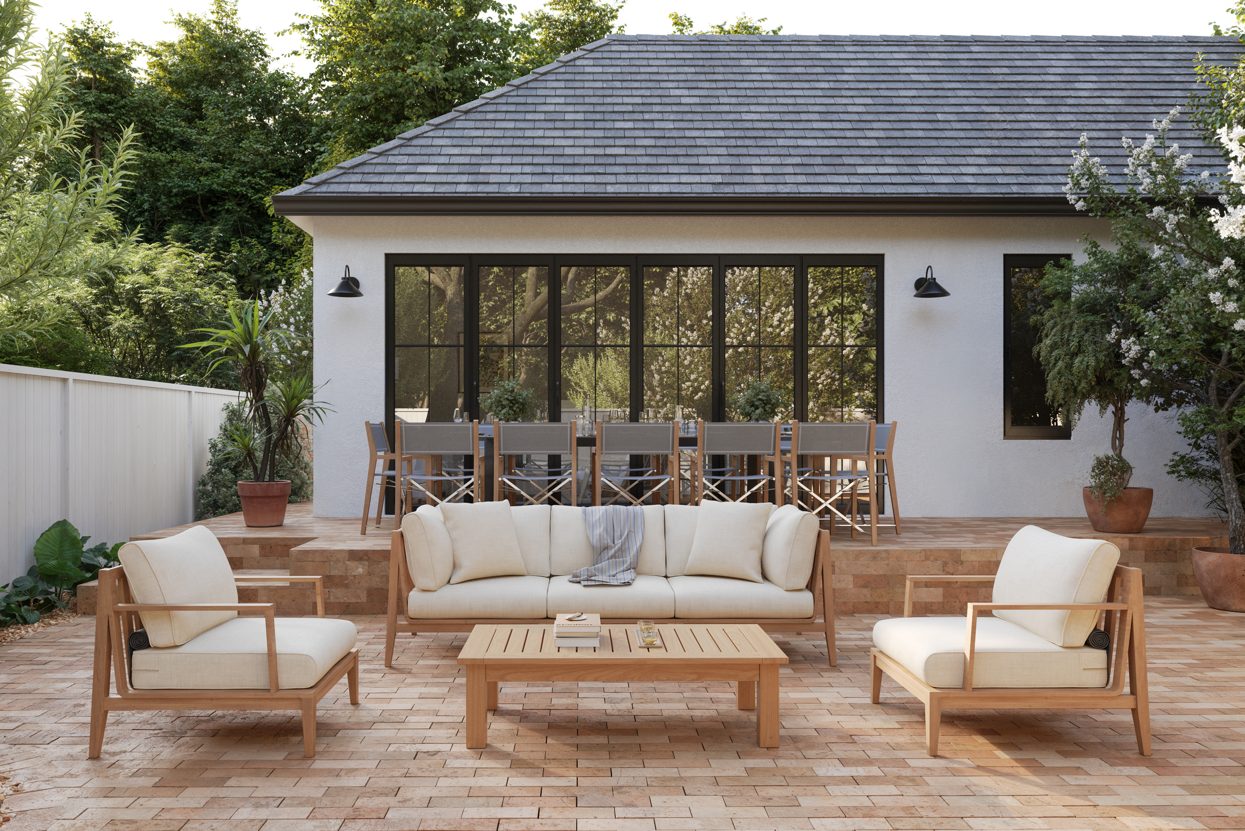 Teak 5-seat outdoor seating set with armchairs and cream cushions on a patio