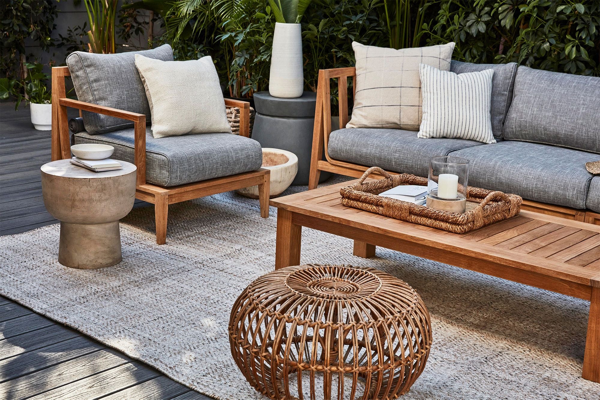 Large square leg coffee table made from sustainable teak shown with Outer's outdoor teak sofa in Pacific Fog Gray cushions.