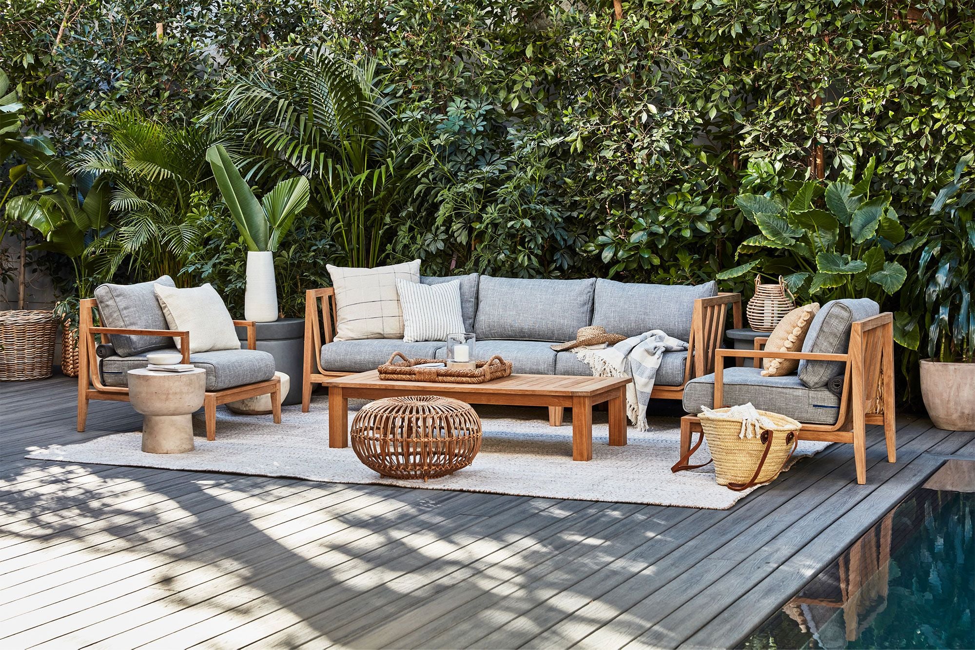 Square leg coffee table shown poolside with the FSC certified teak sofa and armchairs.
