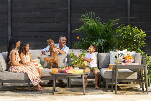Family relaxing on Outer patio furniture with built-in covers in a modern outdoor space