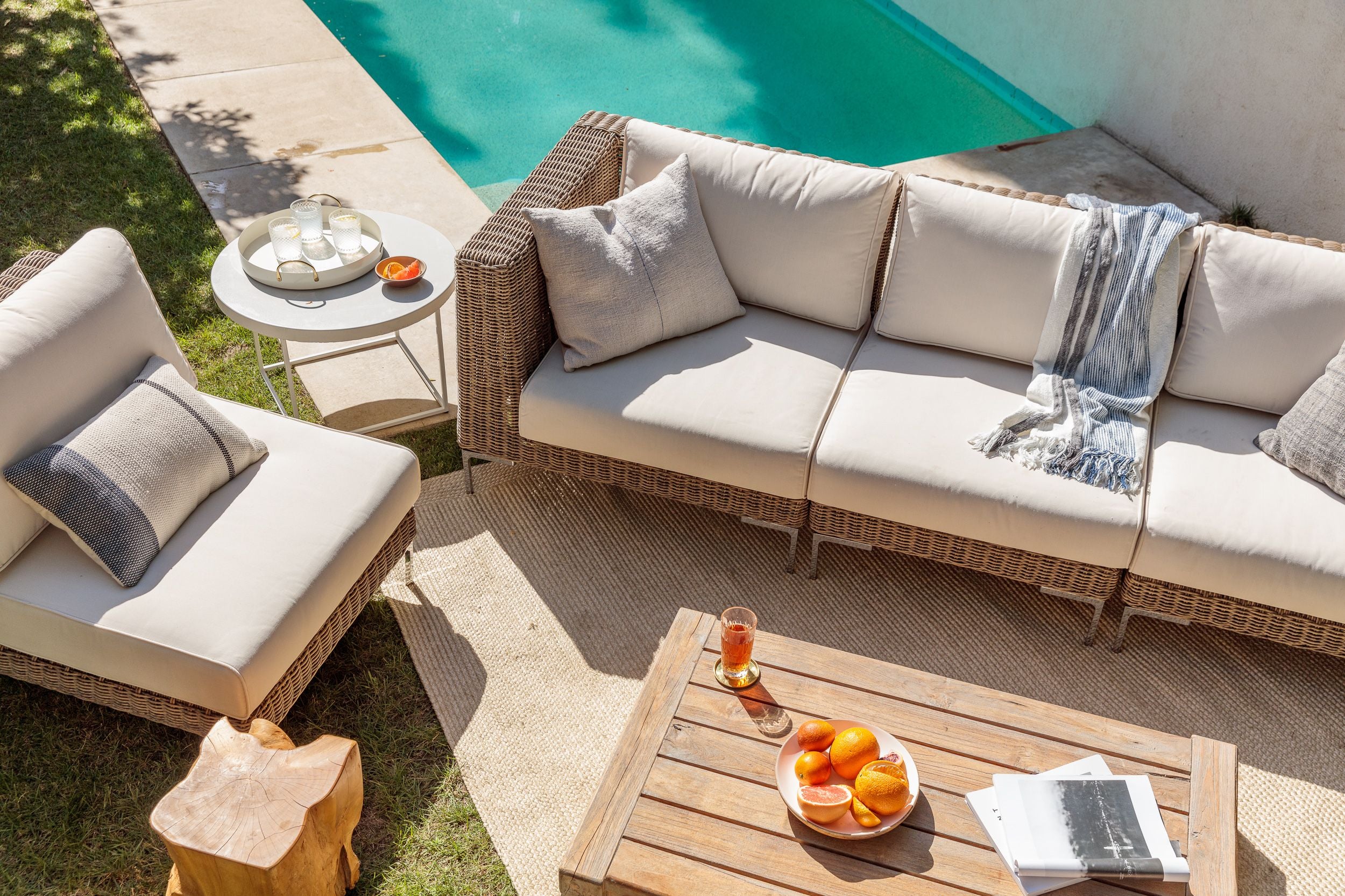 The durable and sustainable outdoor brown wicker sofa with attractive cream color cushions. #color_palisades cream