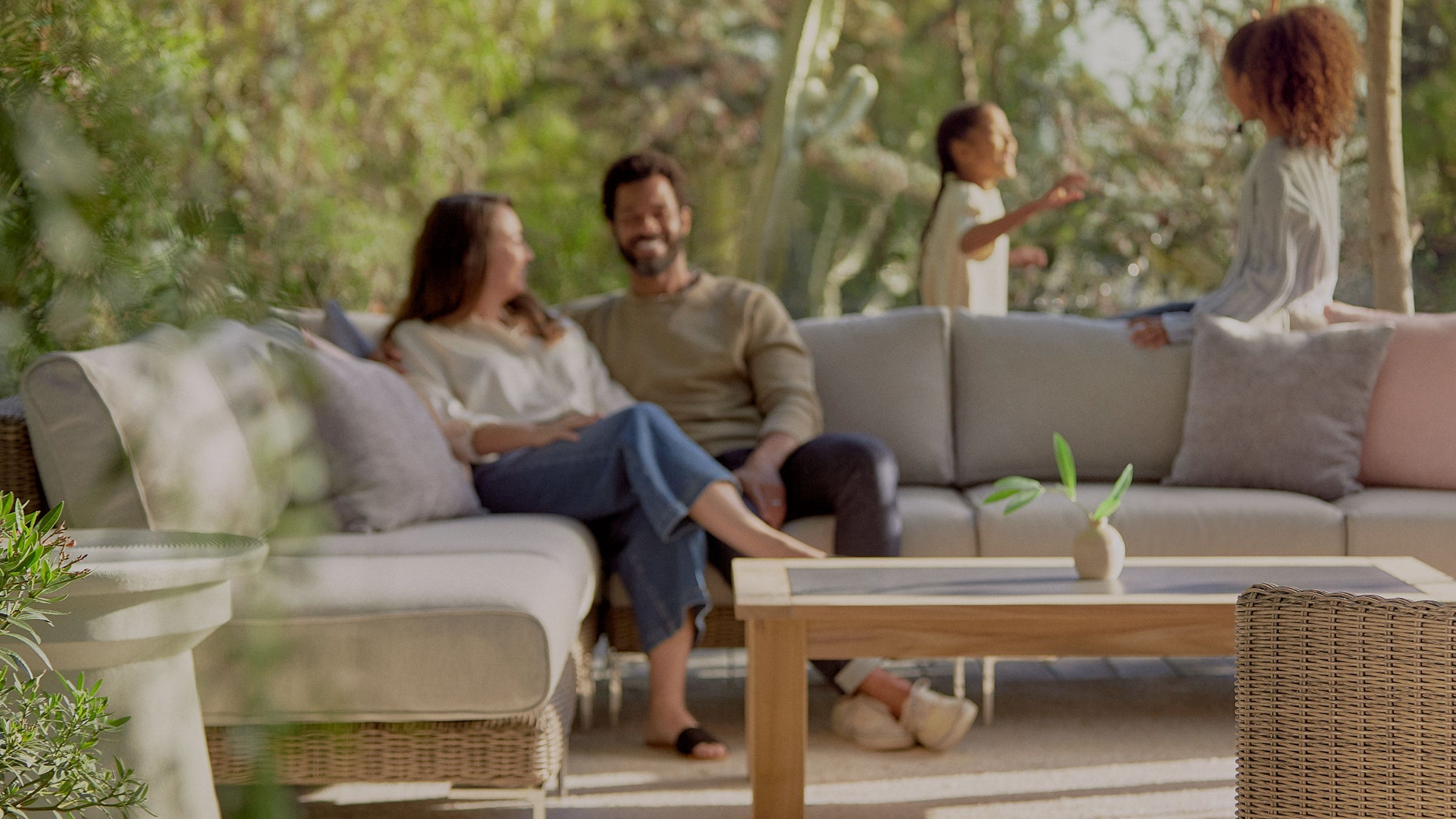 Family relaxing on modern outdoor furniture in a complete backyard living space