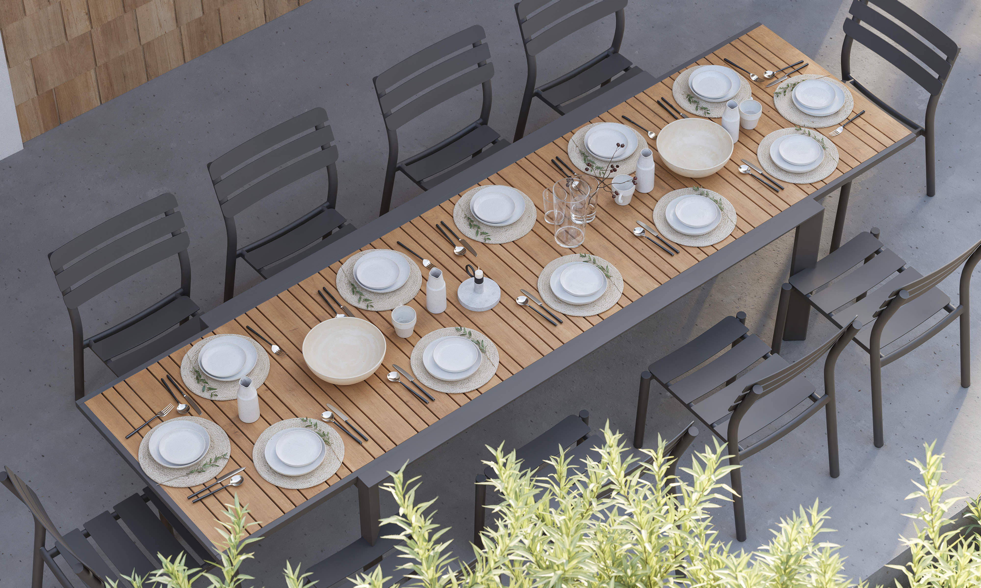 outer-Teak + Aluminum Outdoor Expandable Dining Table + 10 595 Armless Chairs-top down view of long rectangular outdoor expandable dining table set styled for a shared meal with teak tabletop, charcoal aluminum armless chairs, tableware and greenery on modern patio