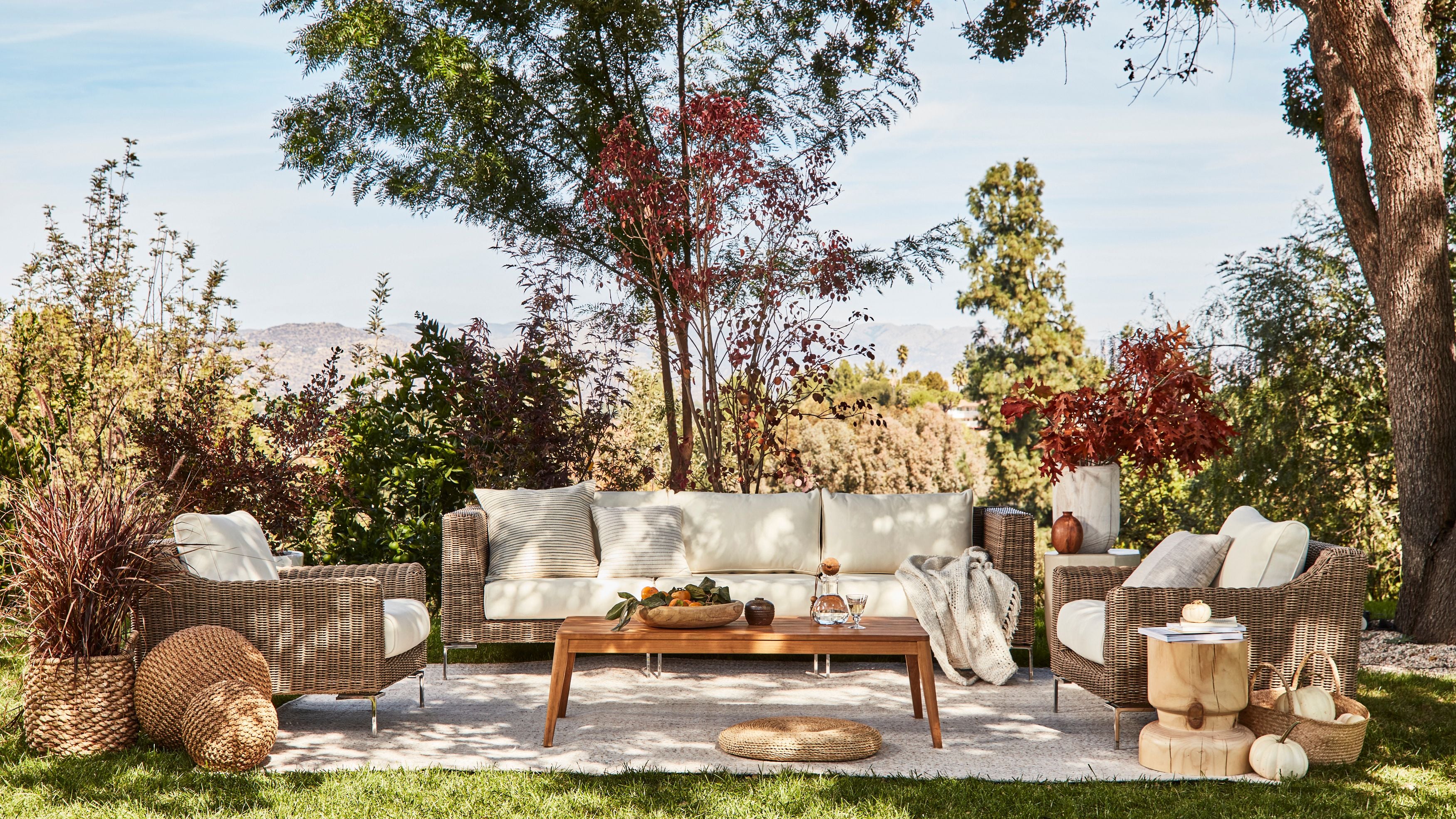 Comfortable and durable all-weather-wicker outdoor sofa in palisades cream with teak coffee table. #color_palisades cream