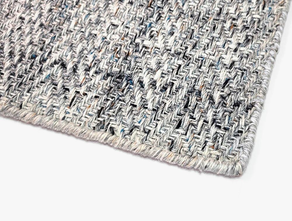 Eco-Friendly Outdoor Rug in Pebble Gray, corner closeup. Durable and sustainable outdoor rug made from recycled plastic bottles. #size_5' x 8'