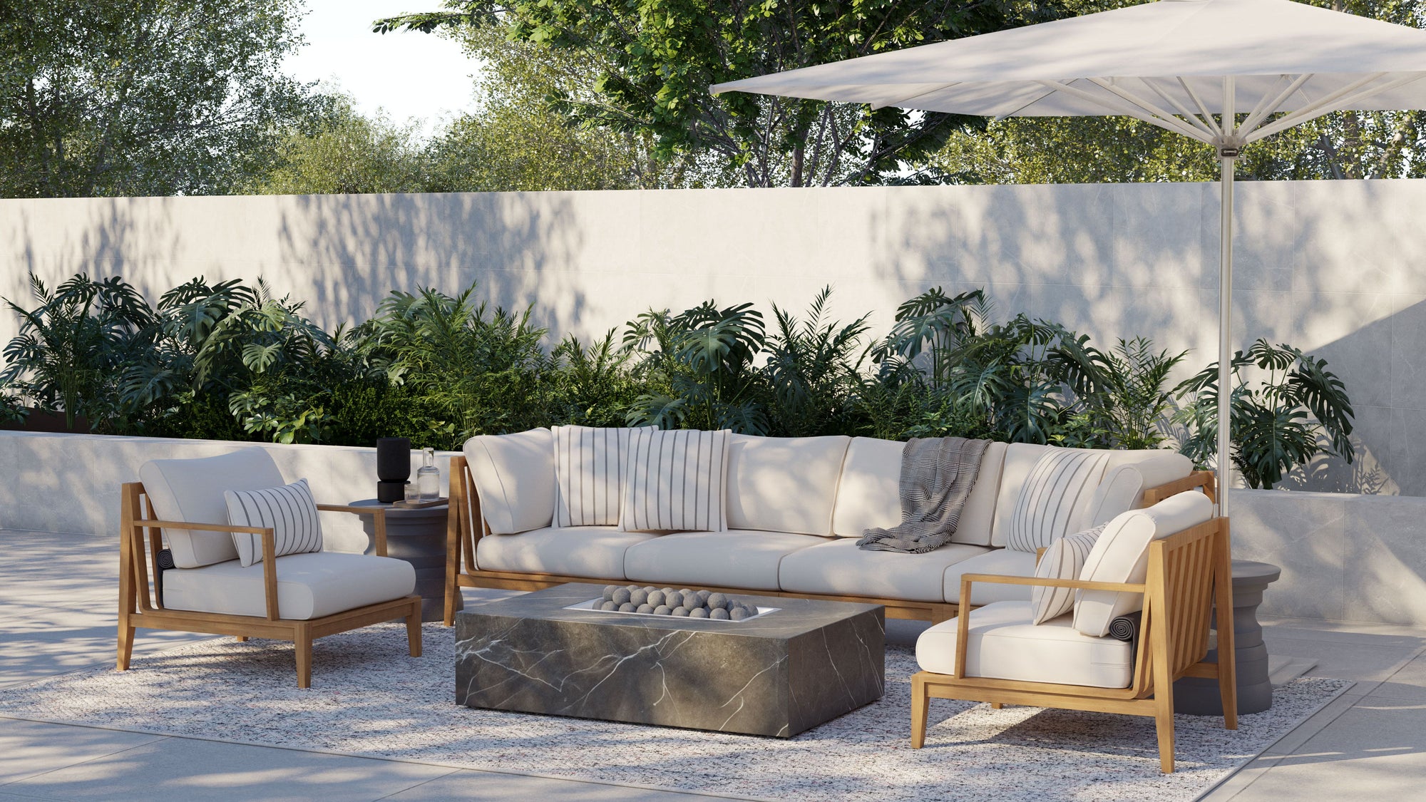 Outdoor sofa and fire pit layout styled with pillows for a comfortable small backyard