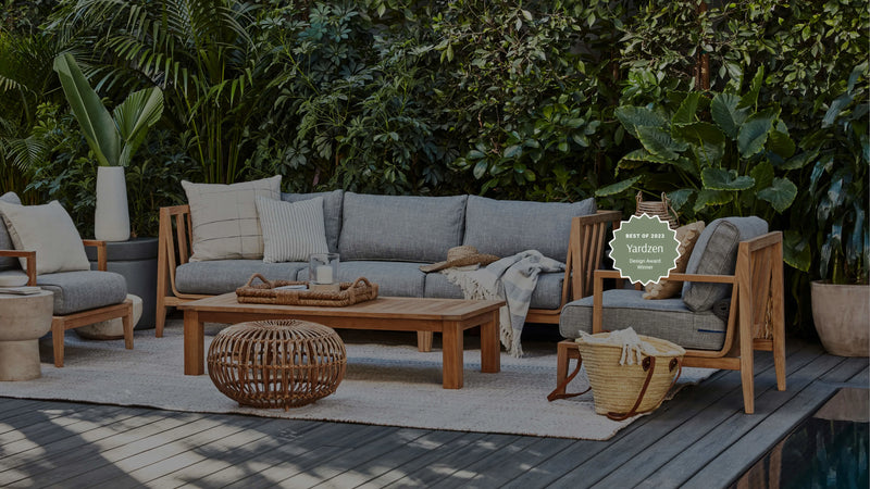 Natural teak Outer outdoor sofa and armchairs on a garden deck