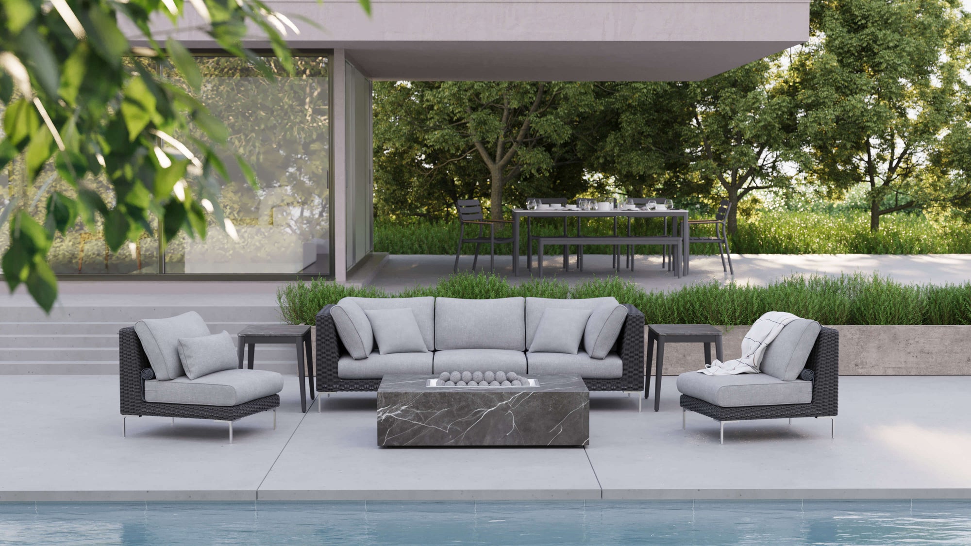 Black wicker outdoor seating arranged around a rectangular OuterStone fire pit table