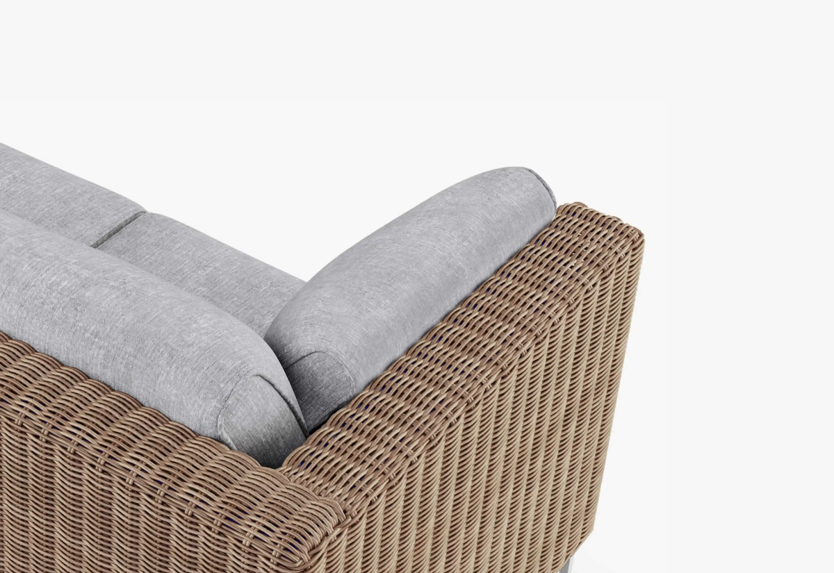 Brown wicker outdoor sofa with UV-resistant cushion protection