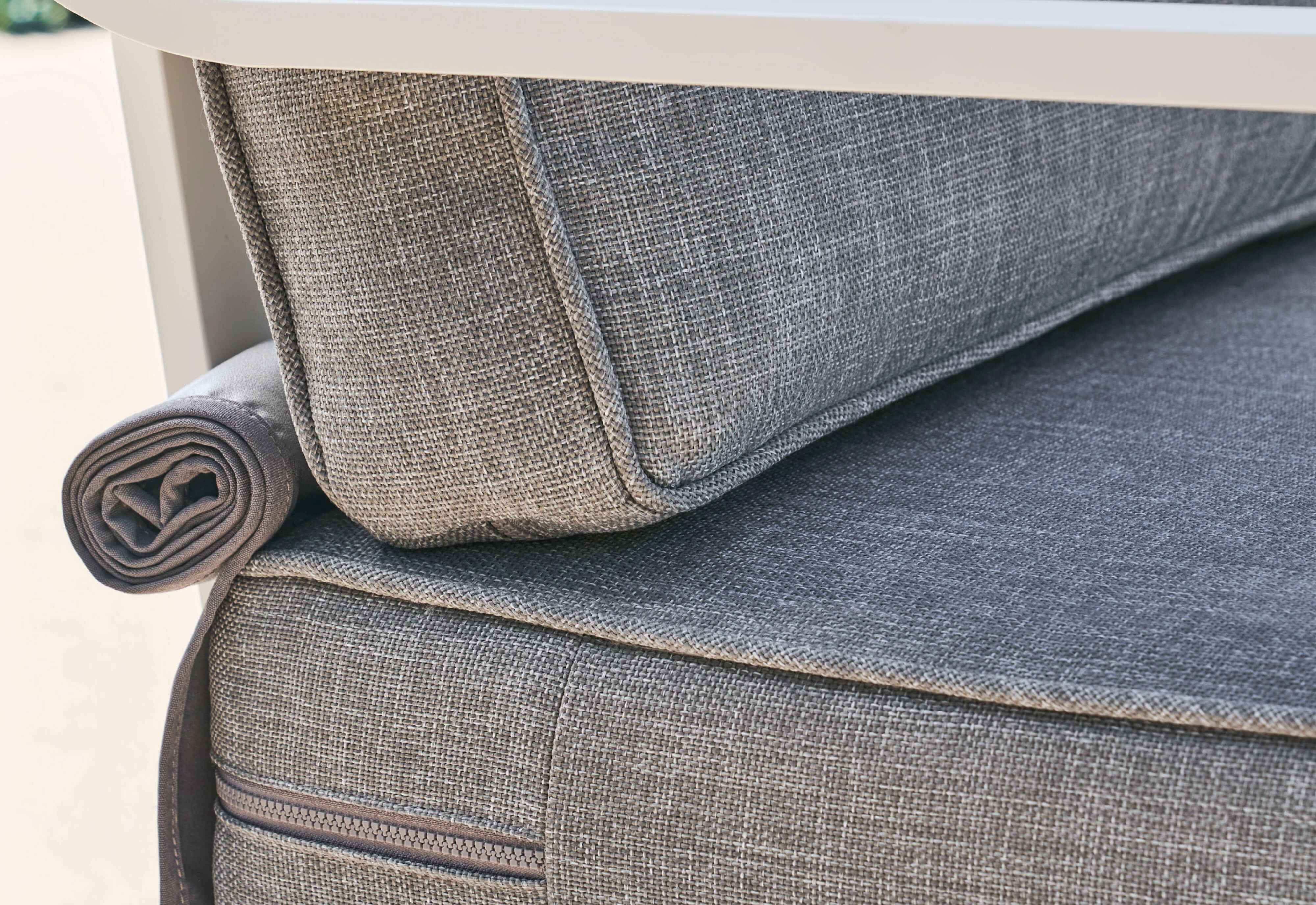 The included OuterShell is shown rolled up behind the back cushion.