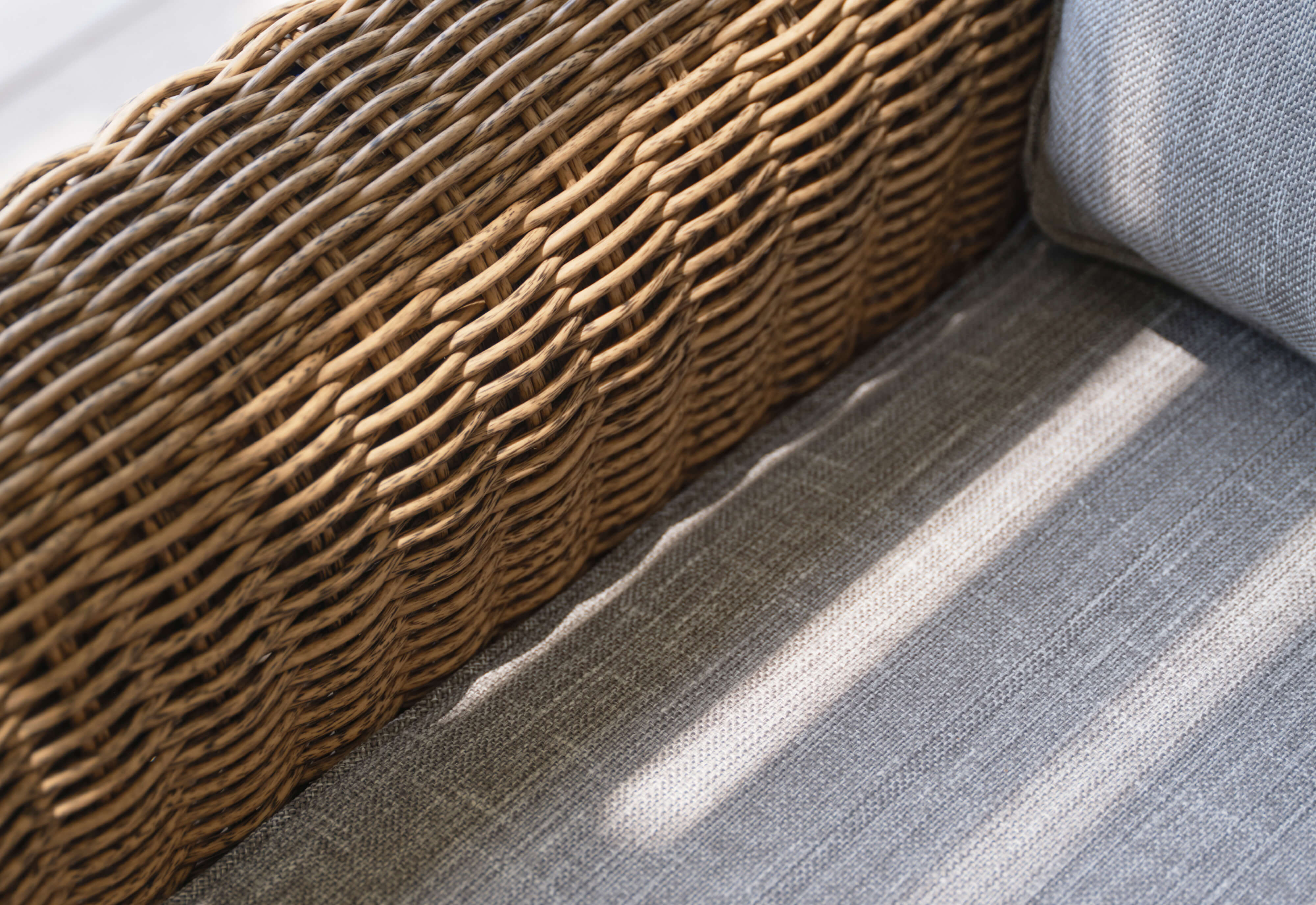 Closeup of the pacific fog gray cushion fabric and artisan all-weather brown wicker weave. #color_pacific fog gray